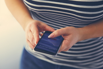 Wall Mural - woman using the smartphone with mobile banking screen, toned image