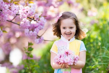 Little girl with cherry blossom