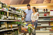 © Syda Productions - couple with wine and shopping cart at liquor store