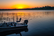 Fishing Boat On Tranquil Lake At Sunset In Minnesota
