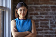 © Monkey Business - Portrait Of Businesswoman In Office Standing By Window