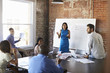 © Monkey Business - Businesswoman At Whiteboard In Brainstorming Meeting