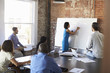 © Monkey Business - Businesswoman At Whiteboard In Brainstorming Meeting