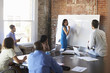 © Monkey Business - Businesswoman At Whiteboard In Brainstorming Meeting