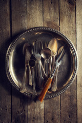 Wall Mural - Vintage Old Rustic Kitchen Utensils Forks Spoons and Knifes on Old Wooden Table. Food or Vintage Rustic Concept. Top View.