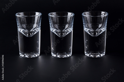 Empty shot glasses on black background - 이 스톡 사진 구입 및 Adobe Stock에서 유사한
