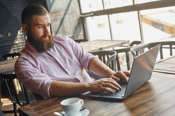 Man in cafe in front of computer