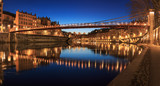 Fototapeta Londyn - Illuminated bridge, Passerelle Saint-Vincent, over the Saone river in Lyon, France.