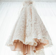 Beautiful stylish wedding dress hanging on the window