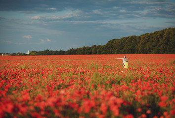 happy man and woman walking through a flower field