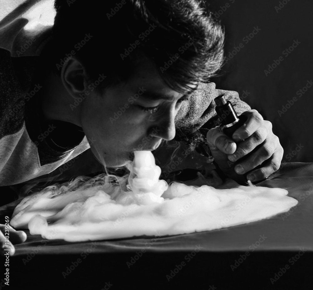 Vape trick waterfall in performance of vaper on dark background Stock Photo  | Adobe Stock
