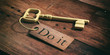 © Rawf8 - Old key with do it on a wooden background. 3d illustration