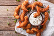 © FomaA - Delicious fried shrimp in coconut chips close-up and sauce on the table. Horizontal top view