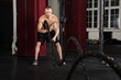 © Andrey Popov - Man Using Training Ropes In A Gym