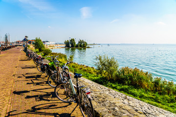  Typical Dutch Bikes parked at the promenade along the inland sea named IJselmeer seen from the historic fishing village of Urk in the Netherlands