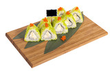 Fototapeta Tęcza - Sushi rolls on wooden Board with leaves of leeks and black sign for logo and name