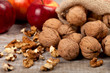 © shandor_gor - Whole walnuts, kernels and apples on the table