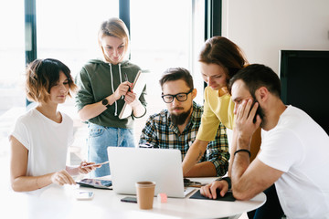 Business people are brainstorming on the new business project. Digital designers are thinking on the new concept for the product. International students are watching at the seminar schedule on laptop.