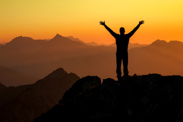 Aufkleber - Happy success winning man on summit arms up at sunset