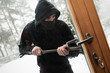 © ronstik - house robbery - robber trying open door with crowbar