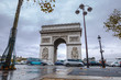 Triumphal arch. Arc de triomphe. View of Place Charles de Gaulle. Famous touristic architecture landmark in rainy day. Long exposure photography. Paris. France.