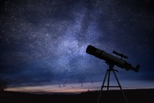 Silhouette Of Telescope And Starry Night Sky In Background. Astronomy And Stars Observing Concept.
