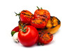 Tomatoes grilled with spices, garlic and red pepper near the toasted bread on a white background