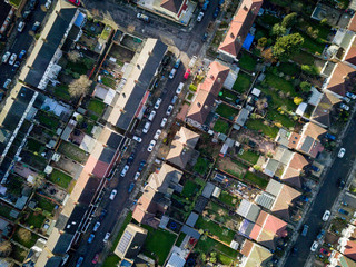 Wall Mural - London suburbs, aerial view. Aerial drone photo looking down vertically onto the rooftops of a typical North London suburban district.