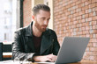 © Africa Studio - Handsome young man working on laptop at cafe