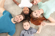 © Africa Studio - Happy interracial family lying on floor