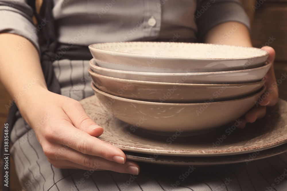 Female hands holding bowls, closeup