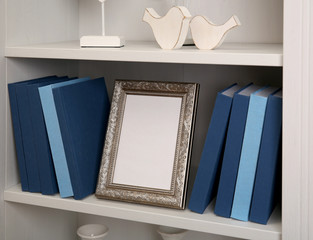 Poster - Set of books in row on white wooden shelving