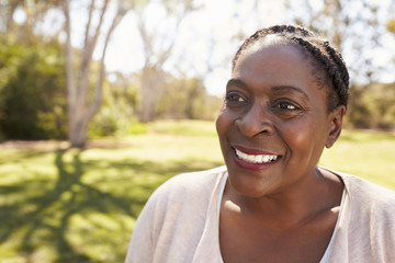 Head And Shoulders Shot Of Mature Woman In Park