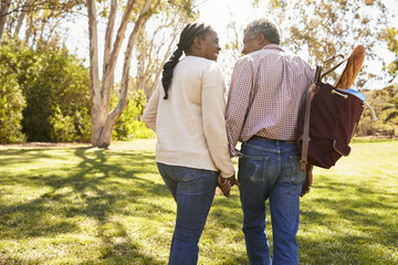 Wall Mural - Mature Couple Going On Picnic In Park Together