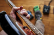 © goodmanphoto - a person playing a guitar and using effect pedals