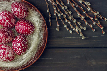 Still life with Pysanka, decorated Easter eggs, on black wooden background