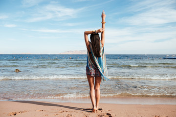 Canvas Print - Back view of Young Woman in beachwear on the beach