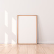 © customdesigner - Poster with Wooden Frame Mockup standing on the floor. 3d rendering