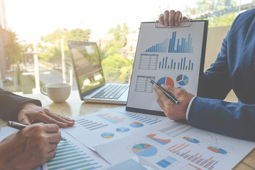 Business concept. Business people discussing the charts and graphs showing the results of their successful teamwork.