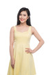 © makistock - Asian young beautiful woman in yellow dress standing over white.