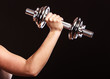 © Voyagerix - athletic woman working with heavy dumbbells