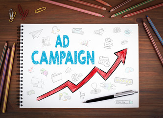 Wall Mural - ad campaign, business concept. notebooks, pen and colored pencils on a wooden table.