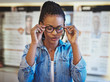 © Flamingo Images - Close up of woman trying out new eyeglasses