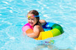 © famveldman - Little girl with toy ring in swimming pool