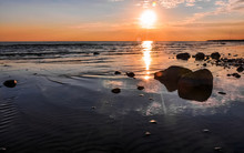 Stones In Water, Waves On Sandy Beach Of Gulf Of Finland And Wonderful Sunset