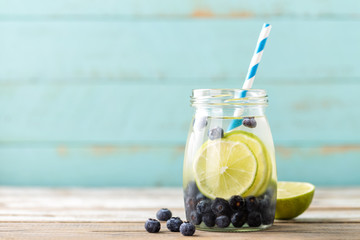 Sticker - infused detox water with lime and blueberry for diet healthy eating and fat burning with space for a text