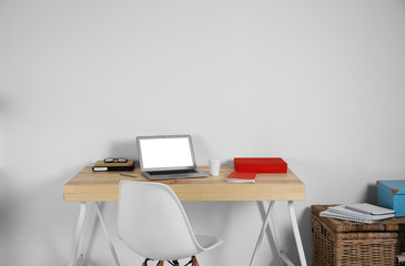 Poster - Workplace with laptop against white wall background