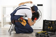 © Africa Studio - Plumber repairing washing machine