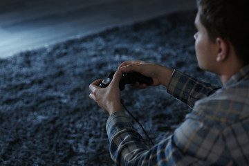 Canvas Print - Teenager playing videogame at home late in evening