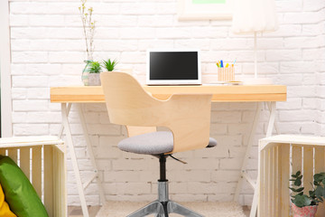 Wall Mural - Workplace with laptop on desk in modern room